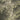 The image is an aerial view of a mountainous region with a mix of green and brown terrain, including hills, valleys, and roads.