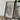 a framed map of Central Africa, with a camera and some books placed on a wooden table in front of it.
