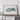 a large framed map of Turkey displayed on a wooden shelf against a white wall.
