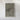 The image is a framed aerial photograph of a mountainous region, with a predominantly green and brown color palette.
