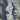 The image is a satellite view of a large body of water, likely the Pacific Ocean, with a densely populated urban area surrounding it. The water appears dark blue, while the land is a mix of green and gray. The image does not contain any text or specific details about the scene.