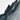 a rugged, rocky cliff face with jagged, uneven surfaces and a textured, weathered appearance.