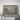 a large landscape print with a tube of paper rolled up next to it, both placed on a white background.