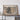 a large framed map of Colorado, with a wooden shelf below it holding a camera and some books.