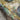 The image is a colorful and abstract geological map, featuring various shades of green, blue, yellow, and black. The map appears to be a collage of multiple images, with some areas overlaid or connected in a way that creates a sense of depth and complexity. The map does not contain any specific text or identifiable objects, and the overall composition is visually striking and intricate.