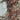 The image is a detailed topographical map of a mountainous region, with various peaks and valleys depicted in different shades of brown and orange. The map includes the coastline and surrounding bodies of water, providing a comprehensive view of the area.