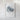The image is a framed artwork depicting a textured, abstract shape resembling a mountain or hill.
