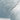 The image is a close-up of a textured surface, possibly a wall or a piece of fabric, with a gradient of blue and white colors. The surface appears to be made of a material with a rough texture, giving it a somewhat rugged appearance.
