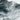 The image is a close-up of a snowy, mountainous landscape with a textured, wavy appearance.