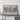 a large world map displayed on a wooden shelf, with a small table and some personal items placed on it.