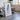 a large, framed artwork depicting a black and white abstract design, placed in a room with a wooden table and chairs.