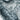 The image is a close-up of a snowy, mountainous landscape with a textured, wintry appearance.