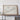 a large framed map of the Atlantic Ocean, with a wooden shelf below it holding a camera and some books.