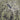 The image is a satellite view of a large lake surrounded by mountains and densely populated urban areas.