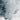 The image is a close-up of a rocky, mountainous terrain with a textured, rocky surface. The predominant colors are gray and white, with some areas of black or dark gray. The image does not contain any discernible text or countable objects, and it does not depict any actions or movements. The image is a single, continuous scene of the rocky, mountainous landscape.