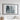 a large, framed artwork depicting a mountainous landscape with a textured, rocky surface.