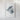a white framed artwork depicting a piece of abstract, textured material.