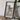 a framed map of Utah, with a camera and some books placed on a wooden table in front of it.