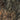 The image is a satellite view of a rugged, mountainous terrain with steep slopes and rocky surfaces.