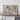 a large framed map of Africa, with a wooden shelf below it holding a camera and some books.