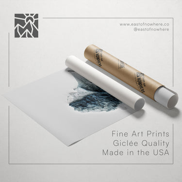 a roll of paper with a printed image of a mountain landscape, along with a tube of paper and a text overlay promoting fine art prints made in the USA.