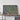 a large framed aerial map of the western United States, with a wooden shelf below it holding a camera and a suitcase.