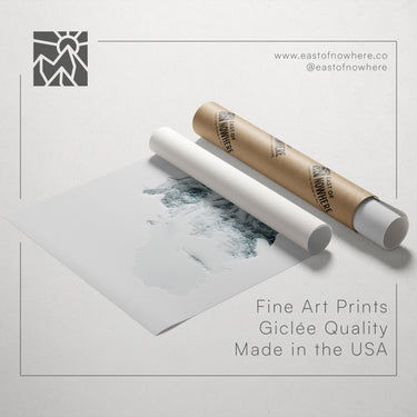 a roll of paper with a drawing of a landscape on it, along with a tube of paper and a text overlay promoting fine art prints made in the USA.
