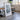 a large framed artwork depicting a mountain landscape, placed in a room with a dining table and chairs.