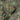 The image is a satellite view of a mountainous region with a mix of green and brown terrain, including hills, valleys, and roads.