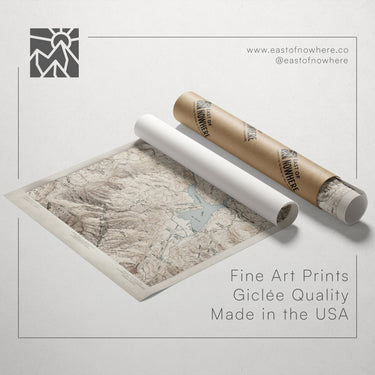 a map of a mountainous region, along with a roll of paper and a tube of paper, all placed on a white background.