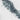 The image is a close-up of a rocky coastline with a rugged, jagged coastline and a white, snowy surface.
