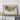 a large framed geological map of the United States, with a wooden shelf below it.