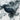 The image is a close-up of a textured surface, possibly a map or a piece of artwork, with a dark, textured area in the center.