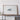 a large white framed artwork depicting a minimalist design on a wooden shelf.