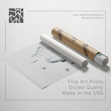 a roll of paper with a drawing of a map and a tube of paper, along with text promoting fine art prints made in the USA.