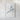 The image is a framed artwork depicting a white mountain or peak against a white background.