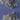 The image is a satellite view of a mountainous region with a body of water in the foreground.