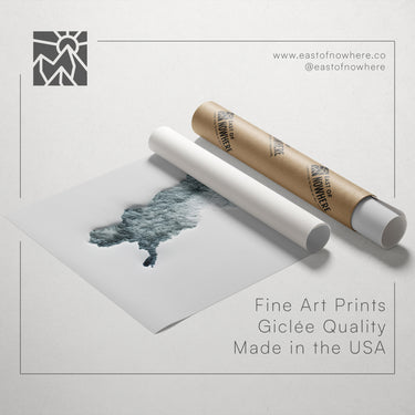 a roll of paper with a printed image of a landscape, along with a tube of paper and a text box containing the text "Fine Art Prints Giclette Quality Made in the USA".