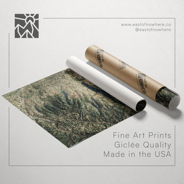 a large landscape print with a tube of paper rolled up next to it, both placed on a white background.