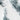 The image is a close-up of a snowy, mountainous landscape with a white, wintry appearance.
