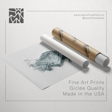 a roll of paper with a drawing of a landscape on it, along with a tube of paper and a website address for fine art prints.