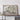 a large framed map of Europe, mounted on a wall above a wooden table.