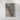 The image is a framed aerial view of a mountainous region, depicting rugged terrain and natural features.