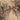 The image is a satellite view of a rugged, mountainous terrain with a mix of brown and gray colors, depicting the ruggedness of the landscape.