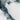 The image is a close-up view of a rocky, mountainous terrain with a predominantly gray and white color palette.