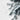 The image is a close-up of a snowy, mountainous landscape with a textured, wintry appearance.