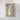 The image is a framed map of a large body of water, likely a lake or ocean, with a label attached to it.