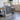 a large framed poster of Catalina Island, with a wooden table and chairs in the background.